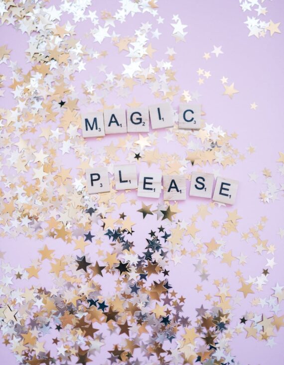 A whimsical background with scattered star confetti and letter tiles spelling 'MAGIC PLEASE'.