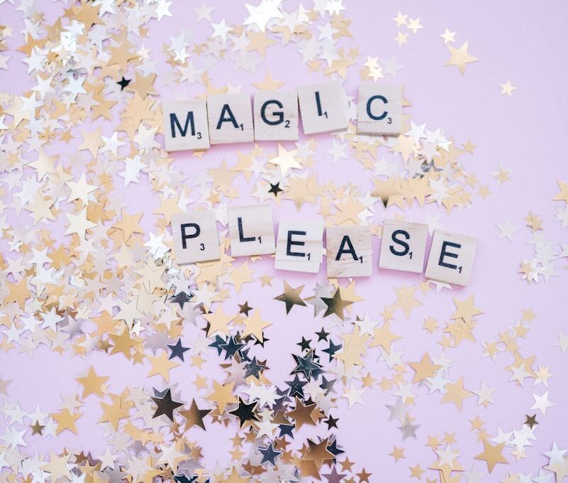 A whimsical background with scattered star confetti and letter tiles spelling 'MAGIC PLEASE'.